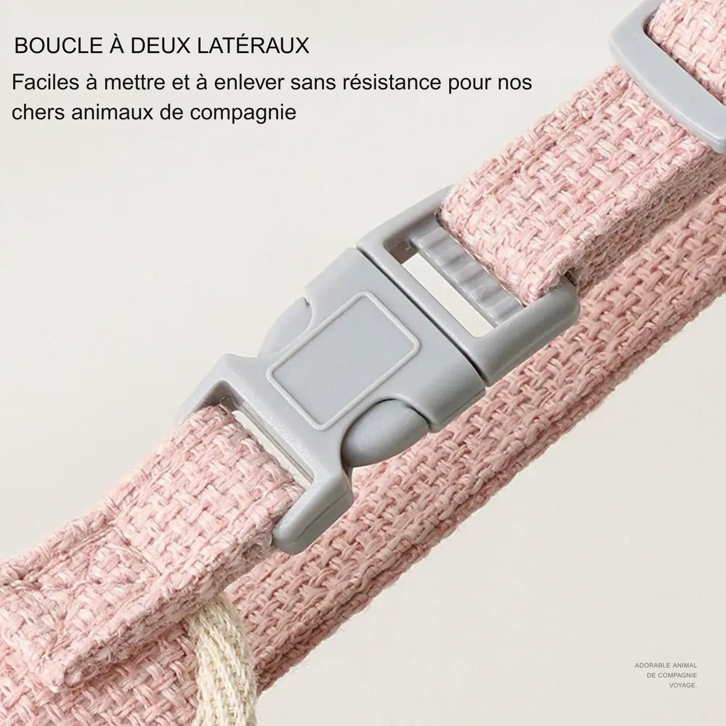 Gros plan sur la boucle de sécurité à deux latéraux d'un harnais pour chat rose. Système de fermeture rapide et sans résistance pour un enfilage facile. Ce harnais chat ajustable en tissu tressé garantit un confort maximal pour les sorties. Un accessoire de type harnais animaux haute qualité conçu pour réduire le stress lors de la mise en place.