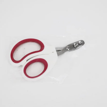 Coupe-ongles double trou pour animaux sous emballage scellé, modèle ergonomique rose foncé et blanc avec orifices de 2 mm et 3,5 mm pour un soin sécurisé des griffes.