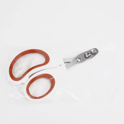 Coupe-ongles double trou pour chat et chien sous emballage de protection transparent, modèle ergonomique rouge et blanc avec lames perforées en acier inoxydable.