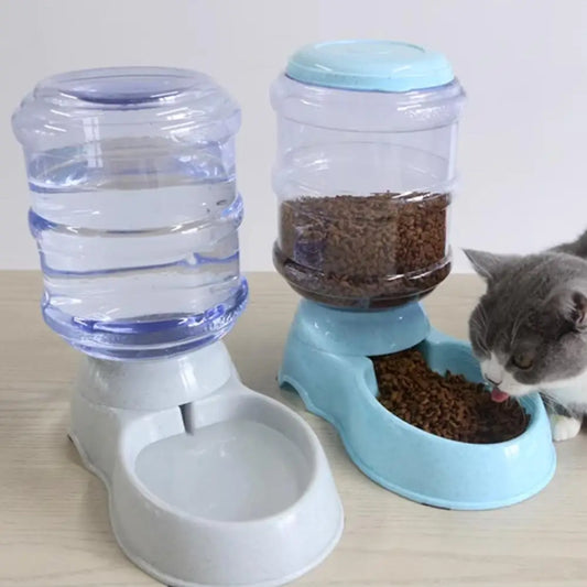 Chat en train de manger dans un distributeur croquettes chat automatique bleu fonctionnant par gravité. À côté, un abreuvoir assorti gris avec grand réservoir d'eau transparent. Ce distributeur croquettes manuel assure une autonomie totale sans piles. Idéal comme distributeur croquettes chien de petite taille pour garantir des repas frais et une hydratation constante.