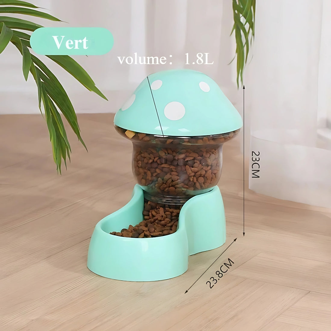 Distributeur de croquettes pour chat vert menthe en forme de champignon, capacité de 1.8L, dimensions 23cm de hauteur par 23,8cm de profondeur, avec réservoir transparent à pois blancs.
