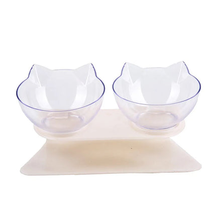Gamelle pour chat double inclinée à 15 degrés avec deux bols transparents design oreilles de chat sur support blanc ergonomique. Cette gamelle chat orthopédique assure un confort cervical optimal, protège la colonne vertébrale et facilite la digestion de votre félin. Une gamelle élégante et moderne pour un coin repas sain et ordonné.