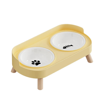 Gamelle pour chat double surélevée au design scandinave jaune pastel avec bols amovibles en céramique blanche et pieds en bois clair. Cette gamelle chat orthopédique décorée d'une patte et d'une arête de poisson assure un confort cervical optimal et une hygiène parfaite pour votre animal. Une gamelle duo robuste et élégante aux finitions premium pour votre intérieur.