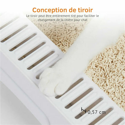Gros plan sur la patte d'un chat blanc sur la grille de sortie d'un bac à litière chat à tiroir. Les fentes de 0,57 cm permettent de capturer les grains, idéal comme bac à litière pour chaton pour garder la maison propre. Conception de tiroir entièrement extractible pour un changement facile de la litière.