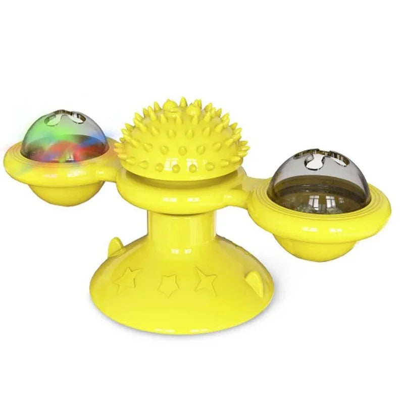 Jouet interactif jaune pour chat en forme de moulin à vent avec ventouse, comprenant deux globes rotatifs transparents et une zone de massage centrale à picots.