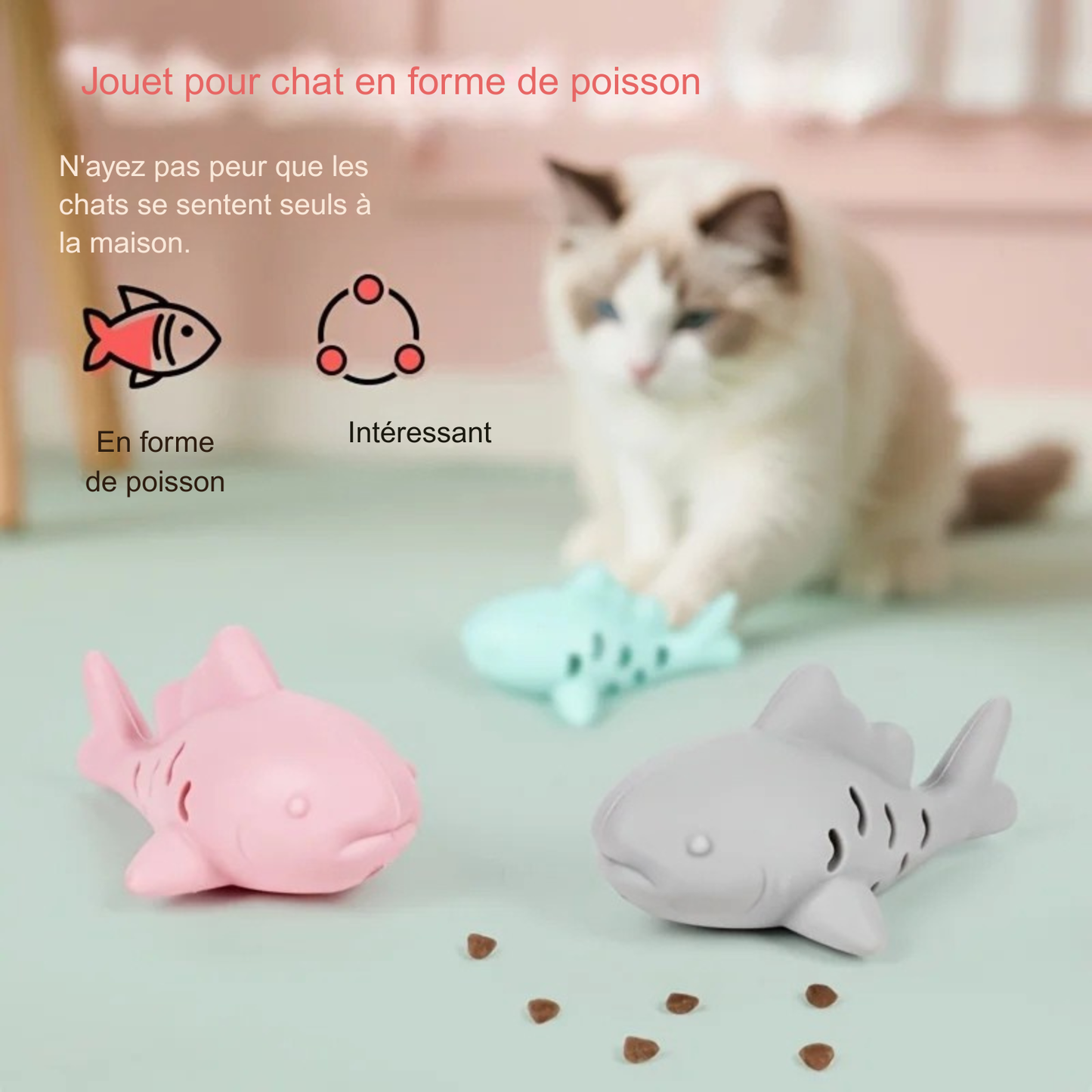 Jouet chat interactif en forme de poisson en silicone rose, gris et vert menthe distribué sur le sol. Ce jeux interactif chat stimule l'instinct de chasse en distribuant des croquettes, idéal pour occuper votre animal seul à la maison. Un accessoire indispensable parmi les jeux animaux pour lutter contre l'ennui.