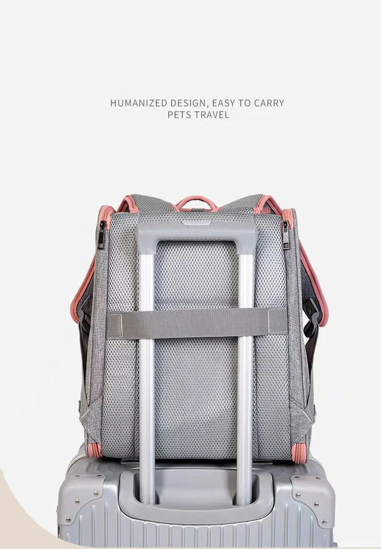 Vue arrière d'un sac à dos de transport pour chat gris et rose fixé sur la poignée télescopique d'une valise grâce à sa sangle trolley intégrée et son dossier en maille respirante.