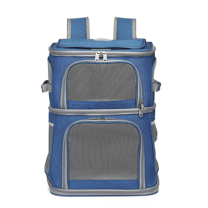 Sac à dos de transport bleu pour deux chats avec double compartiment superposé, doté de larges fenêtres frontales en maille filet noire, de fermetures éclair robustes et de poches latérales de rangement.
