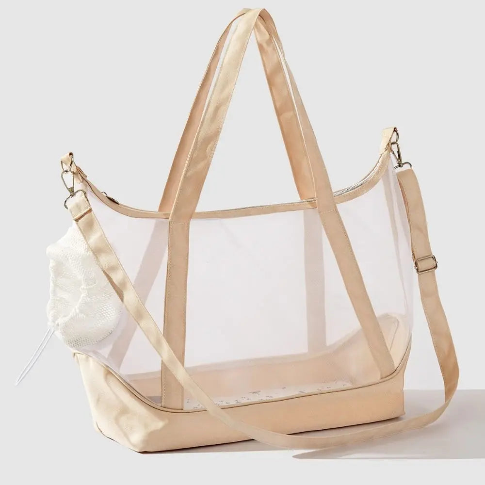 Sac de transport transparent pour chat beige sable type tote bag avec vue panoramique, comprenant de grandes anses, une bandoulière d'épaule réglable et un filet de protection souple.
