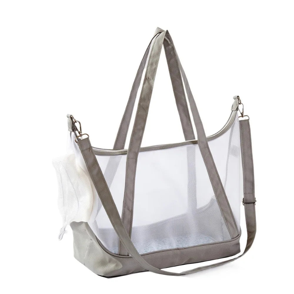 Sac de transport transparent pour chat gris type tote bag avec vue panoramique, comprenant de grandes anses, une bandoulière d'épaule réglable et un filet de protection souple blanc.