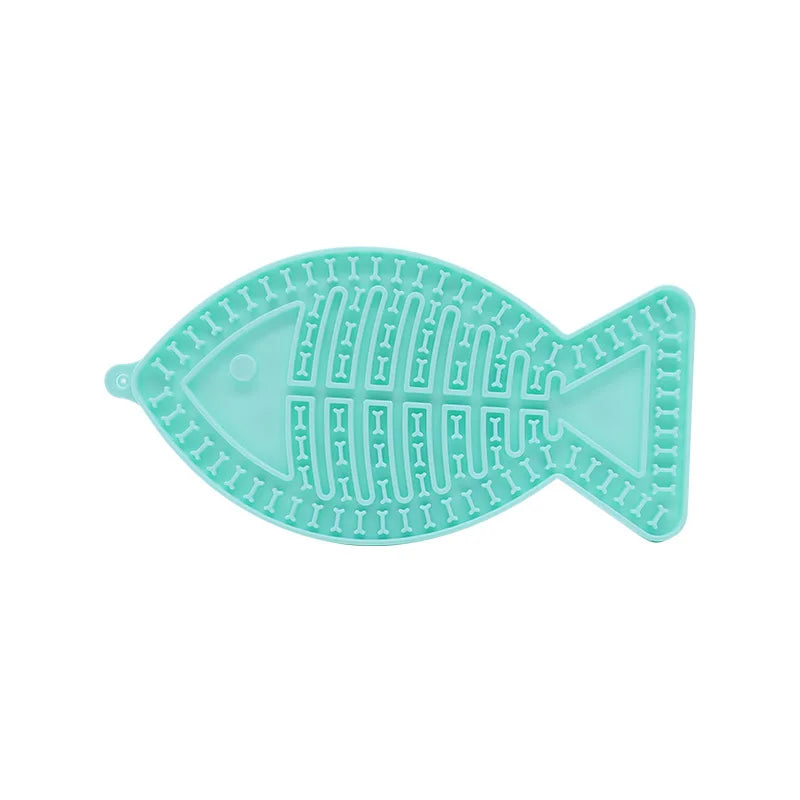Tapis de léchage en silicone alimentaire vert menthe en forme de poisson pour chat et chien. Ce tapis à lécher anti-stress avec textures en relief favorise l'apaisement et ralentit la prise alimentaire. Un tapis léchage ergonomique avec ventouses idéal pour l'occupation mentale de votre animal.