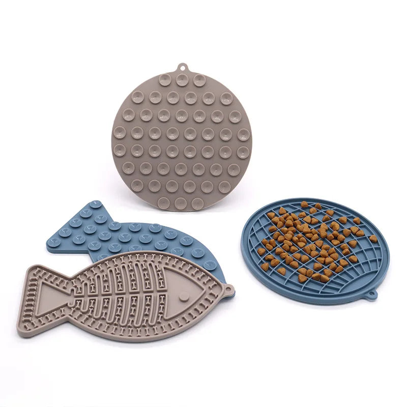 Gamme de tapis de léchage en silicone alimentaire pour chien et chat, incluant un modèle poisson avec ventouses de fixation. Ce tapis à lécher anti-anxiété avec textures variées permet une occupation mentale saine et ralentit la prise alimentaire. Un tapis léchage ergonomique et robuste pour apaiser votre animal pendant les soins.