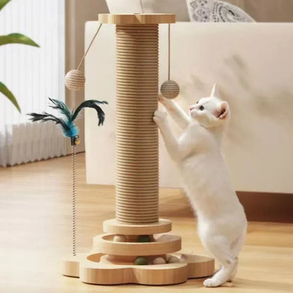 Chat blanc s'étirant sur une tour de jeu interactive en bois clair comprenant un haut poteau à griffer en sisal, un circuit de balles à la base et des balles suspendues interactives.